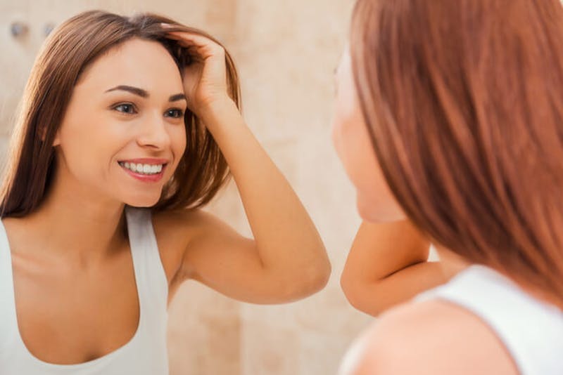 woman looking in the mirror