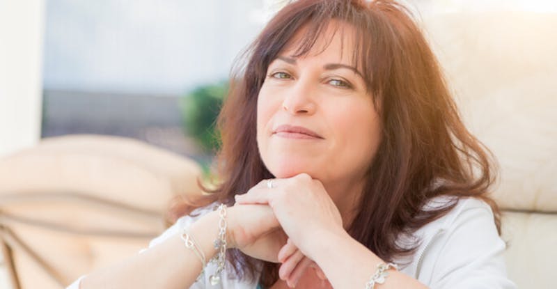 woman resting her face on her hands