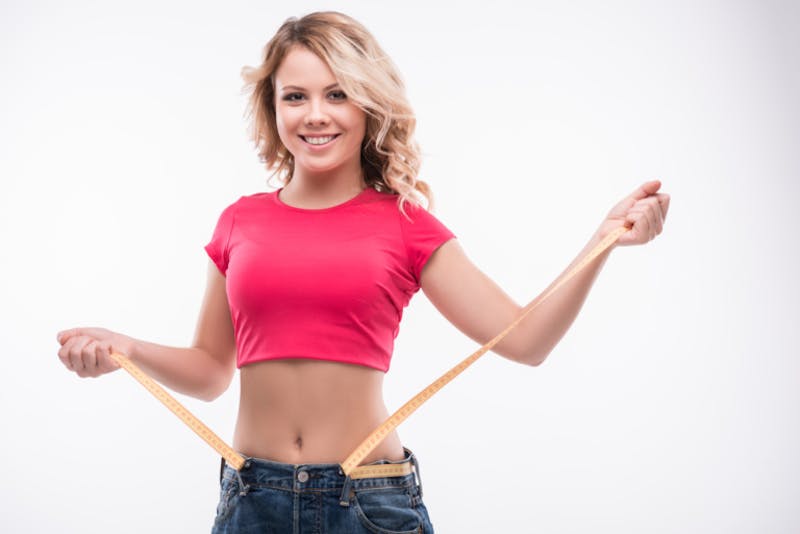 woman measuring her waist