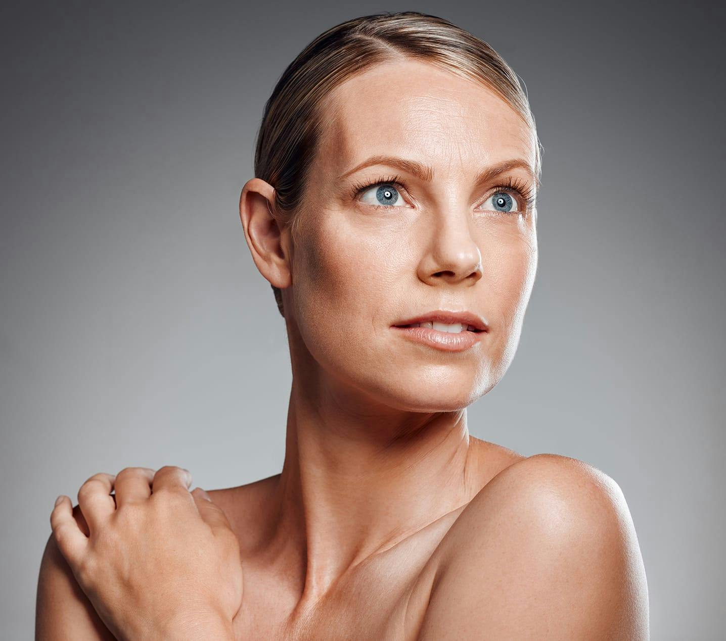 blond woman with blue eyes and no shirt posing for a picture