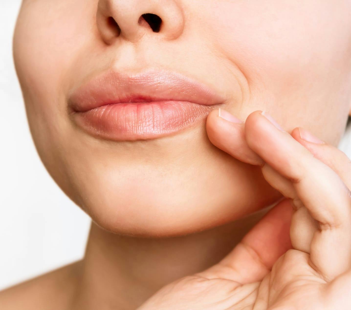 someone touching their lip