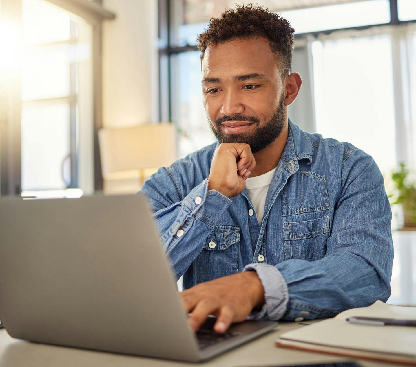 there is a man sitting at a table with a laptop