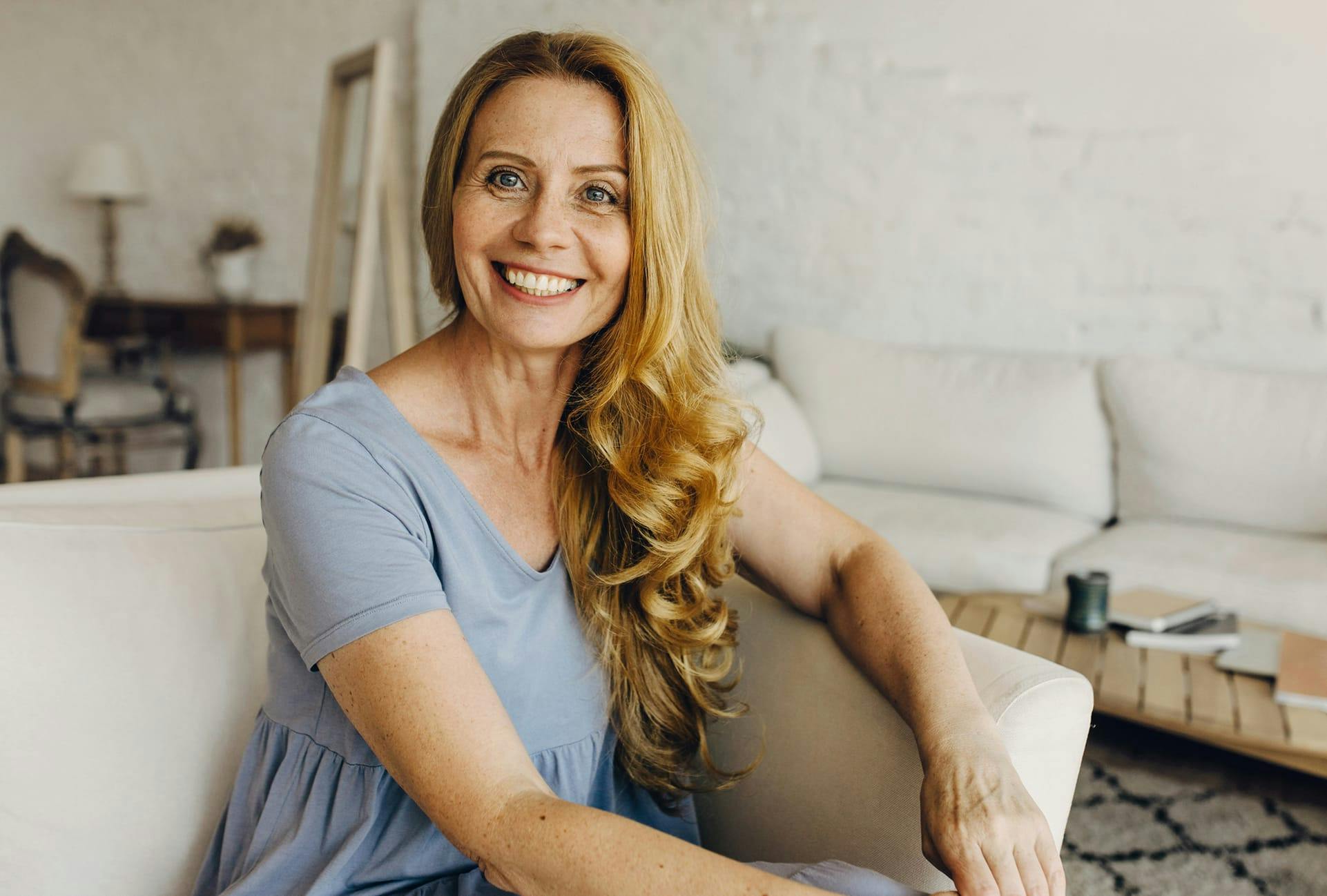 Woman sitting down and smiling