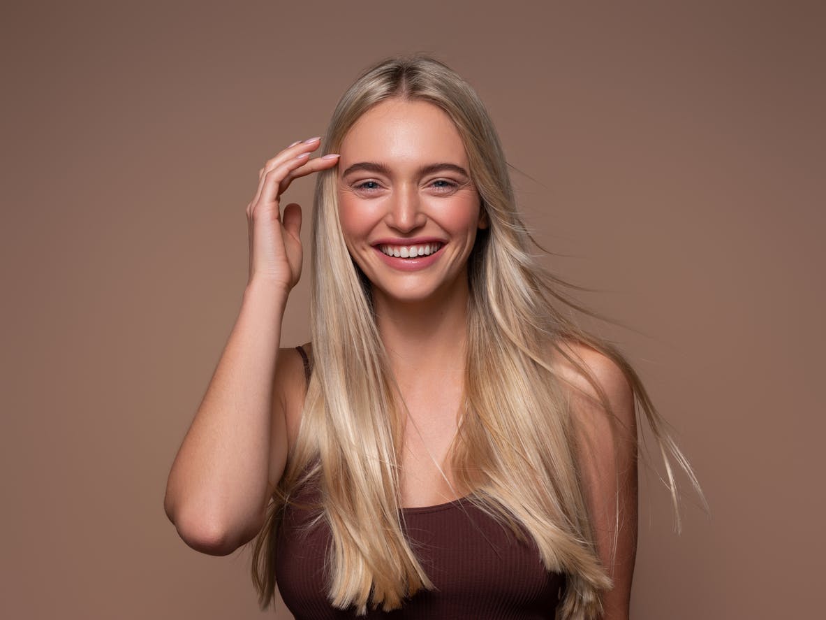 woman with long blonde hair smiling