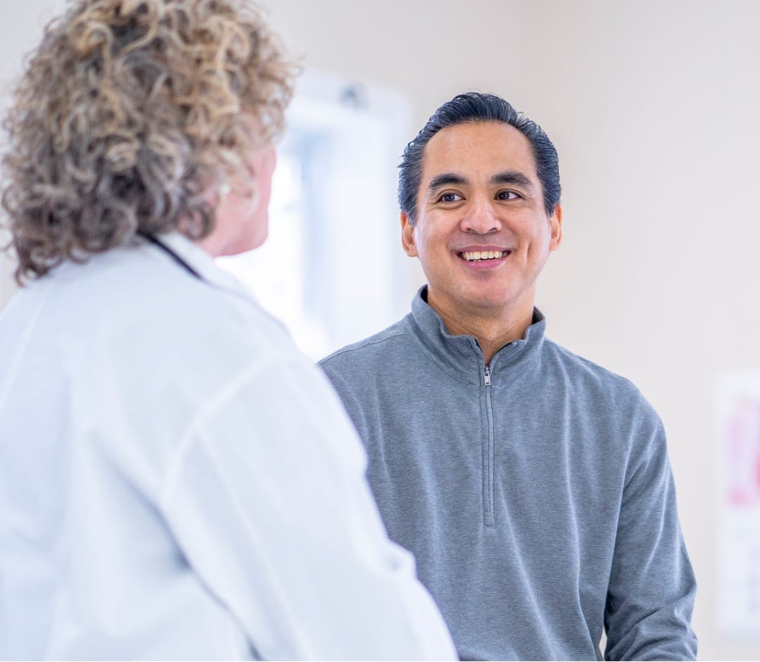 Female ENT surgeon talking with patient