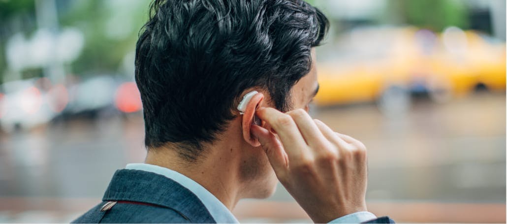Man with hearing aid in his ear