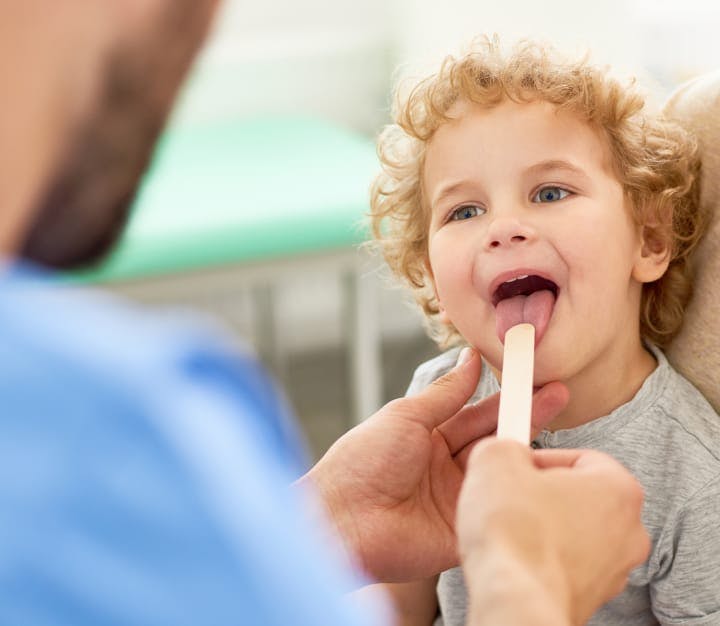 Pediatric ENT examining a young patient