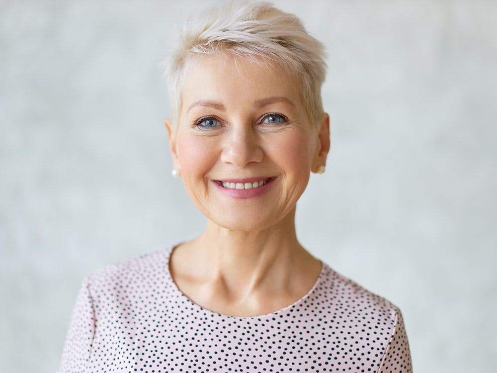 A woman in her 50s after a beautiful facelift result