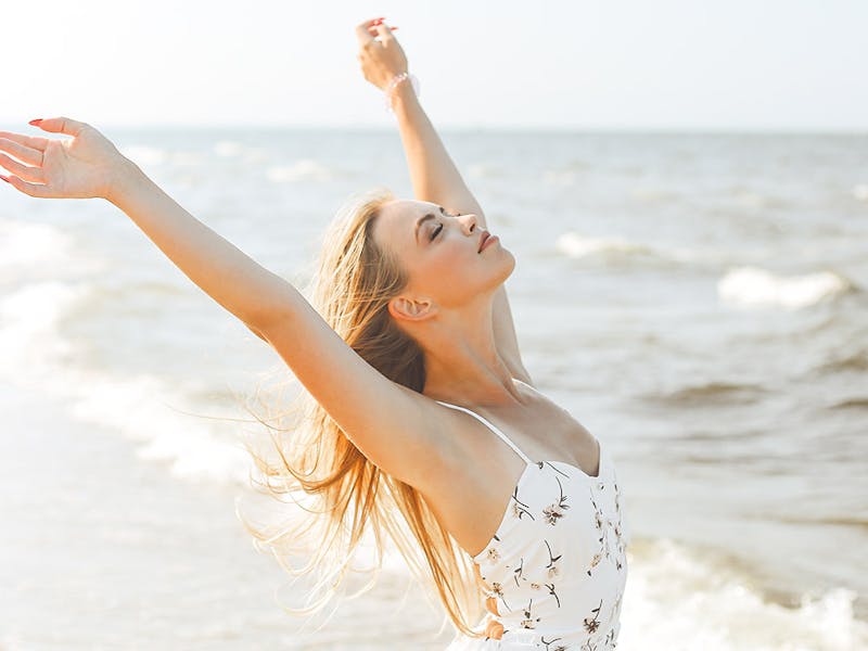 A woman at the beach with well toned arms