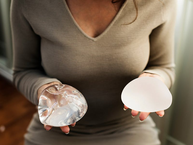 A patient holding two different types of implants