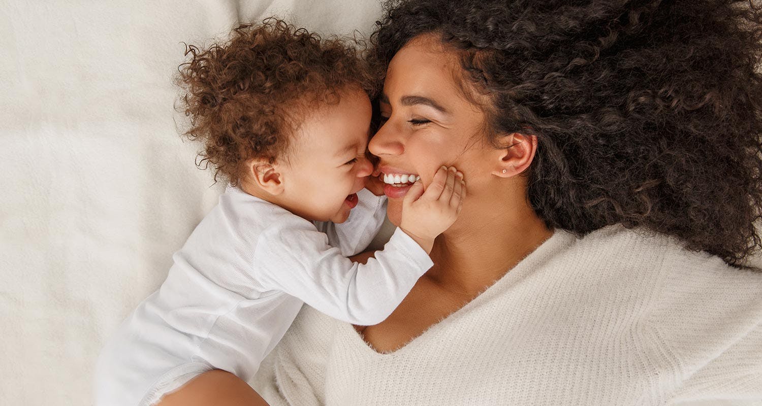 Mom and her baby smiling together