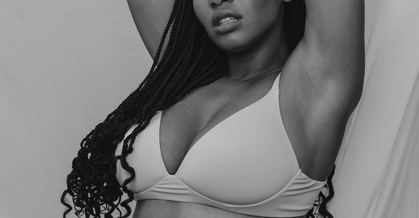 woman in bra with hands above head