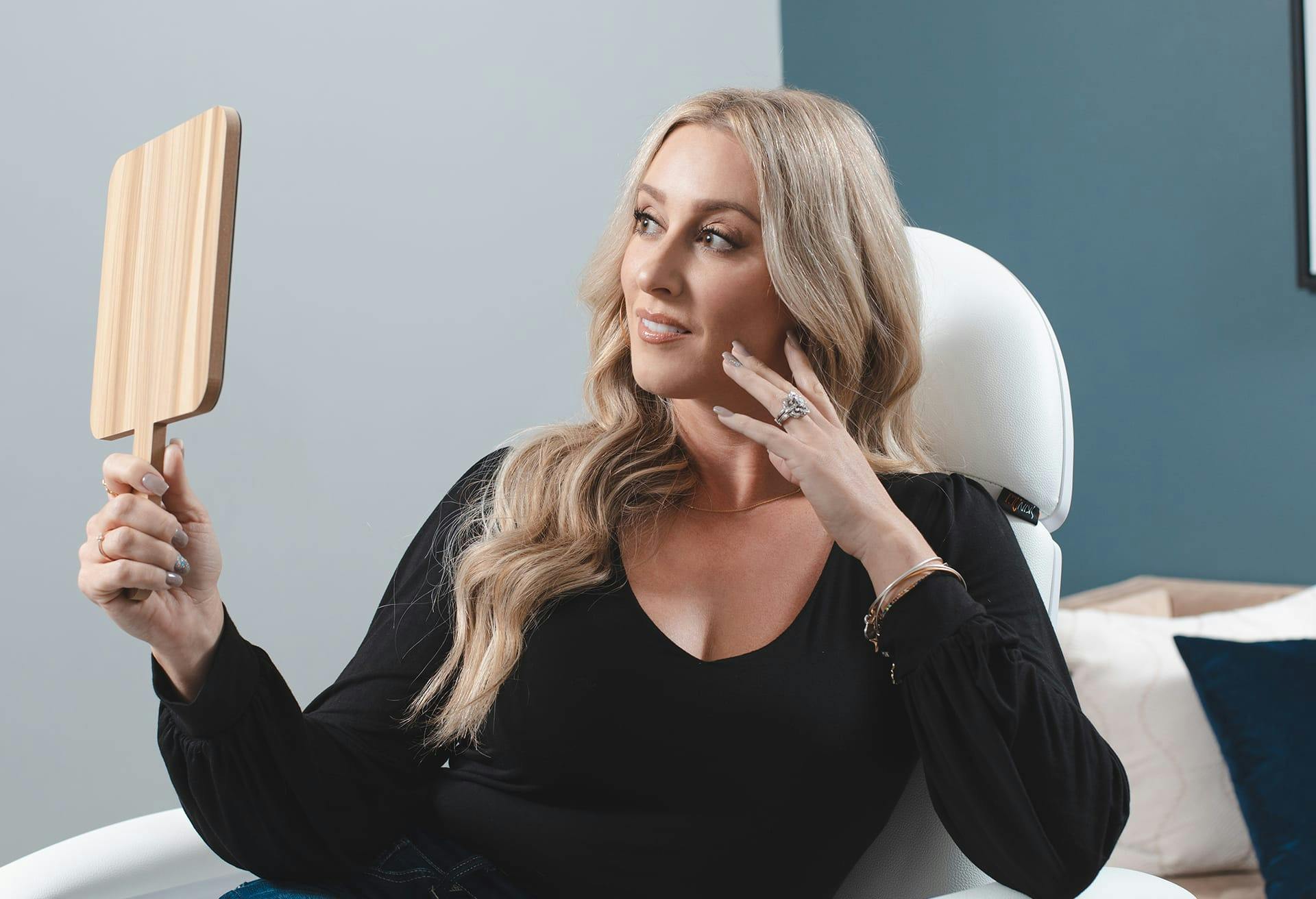 Woman Looking at Her Results in the Mirror