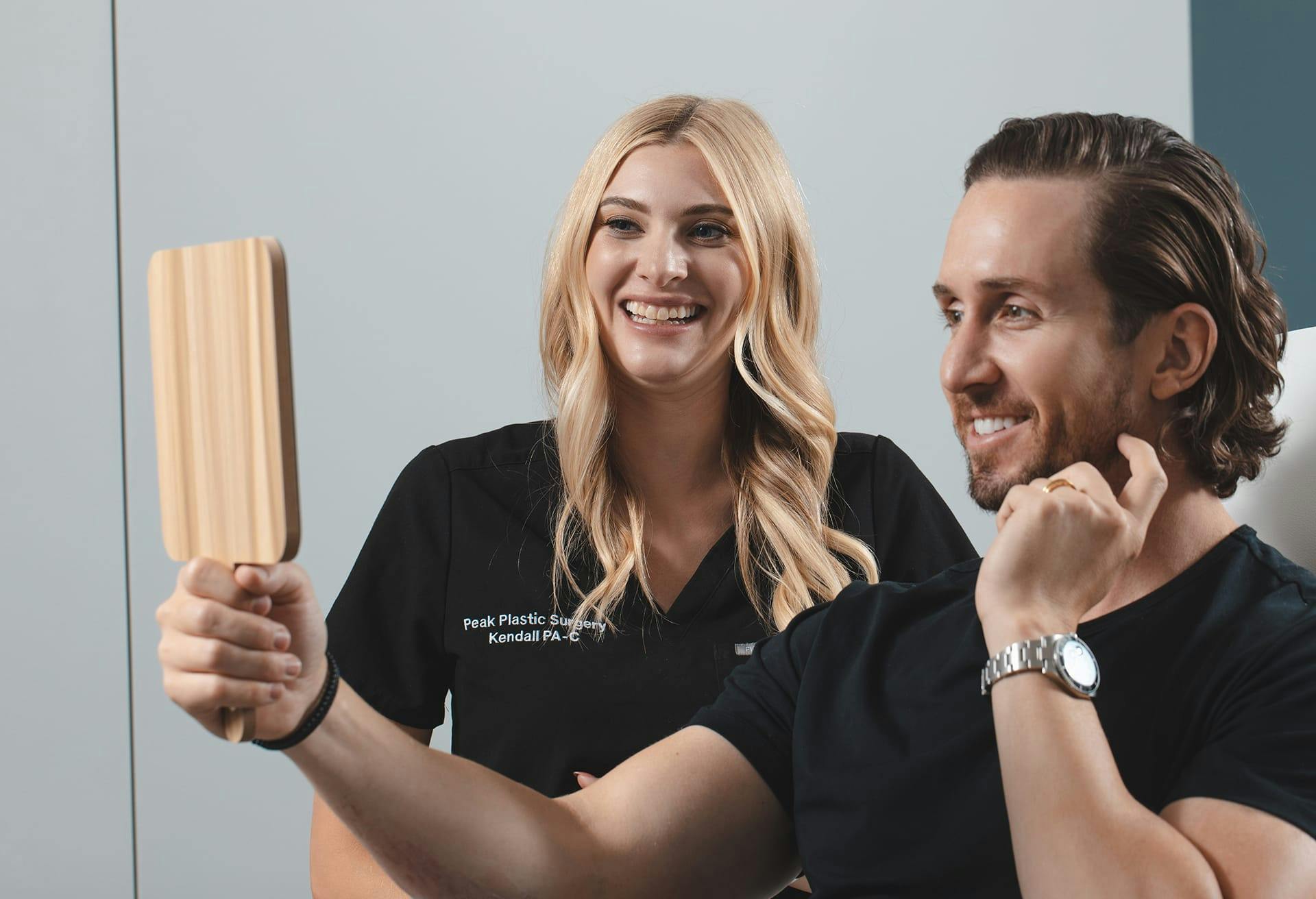 Kendal and Patient Smiling and Looking at His Results