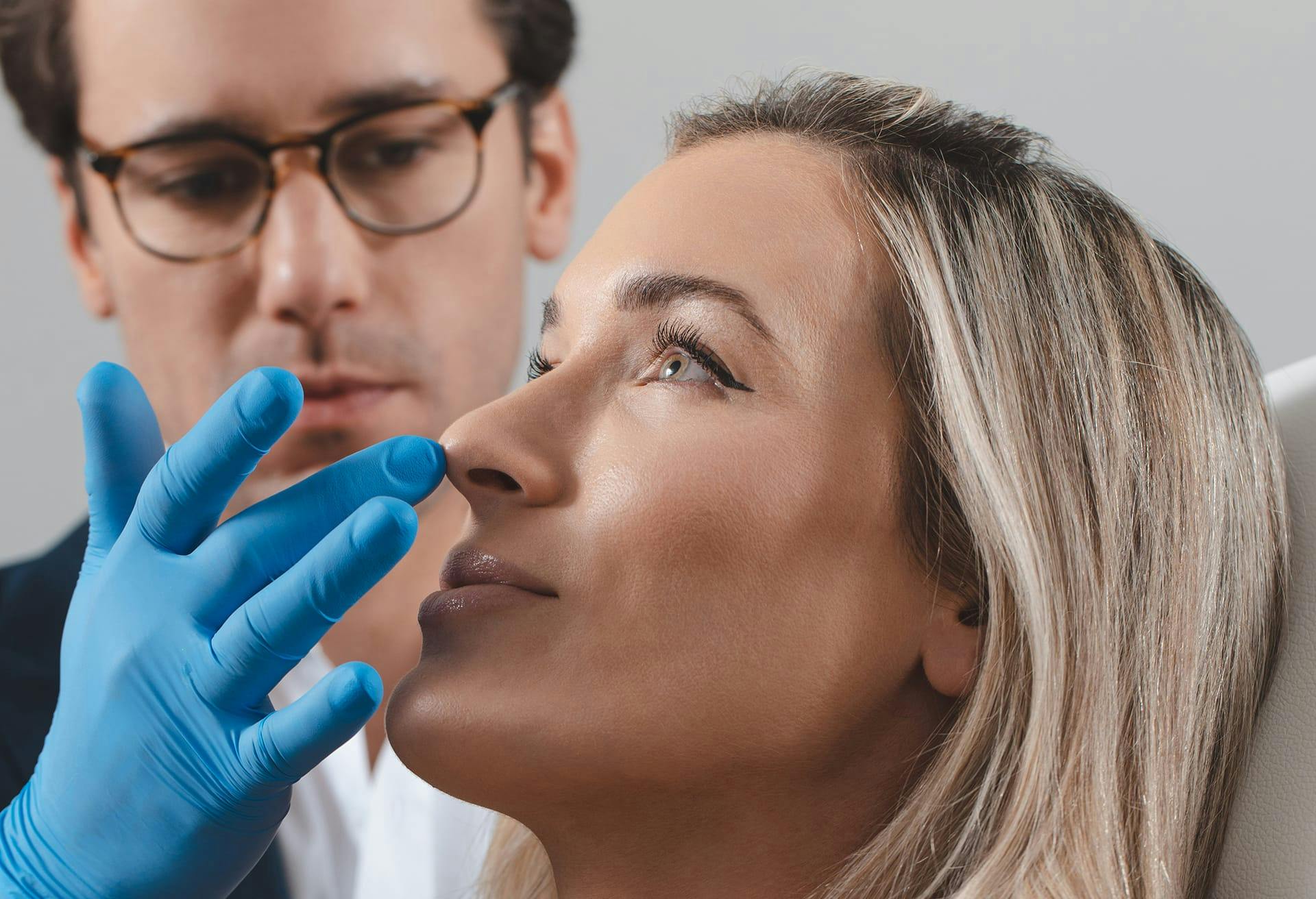 Doctor touching patient's nose