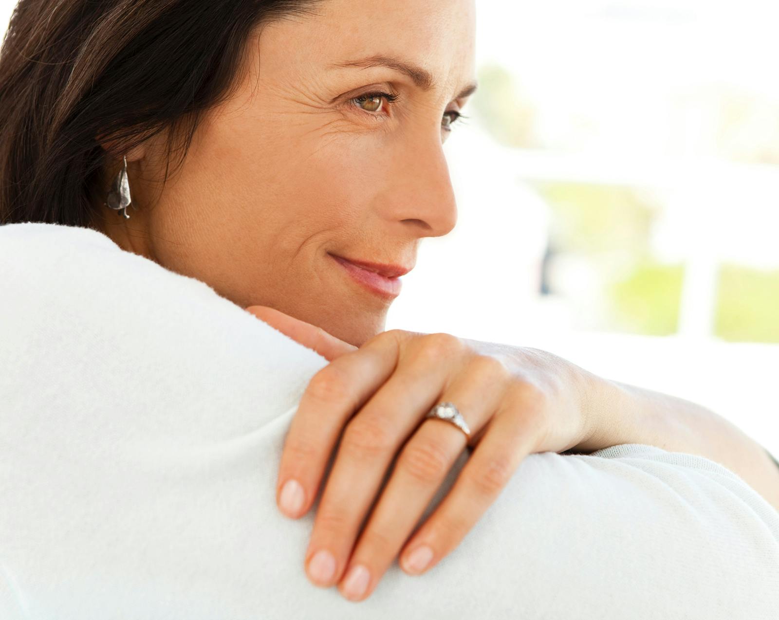 Side profile of a middle-aged woman smiling