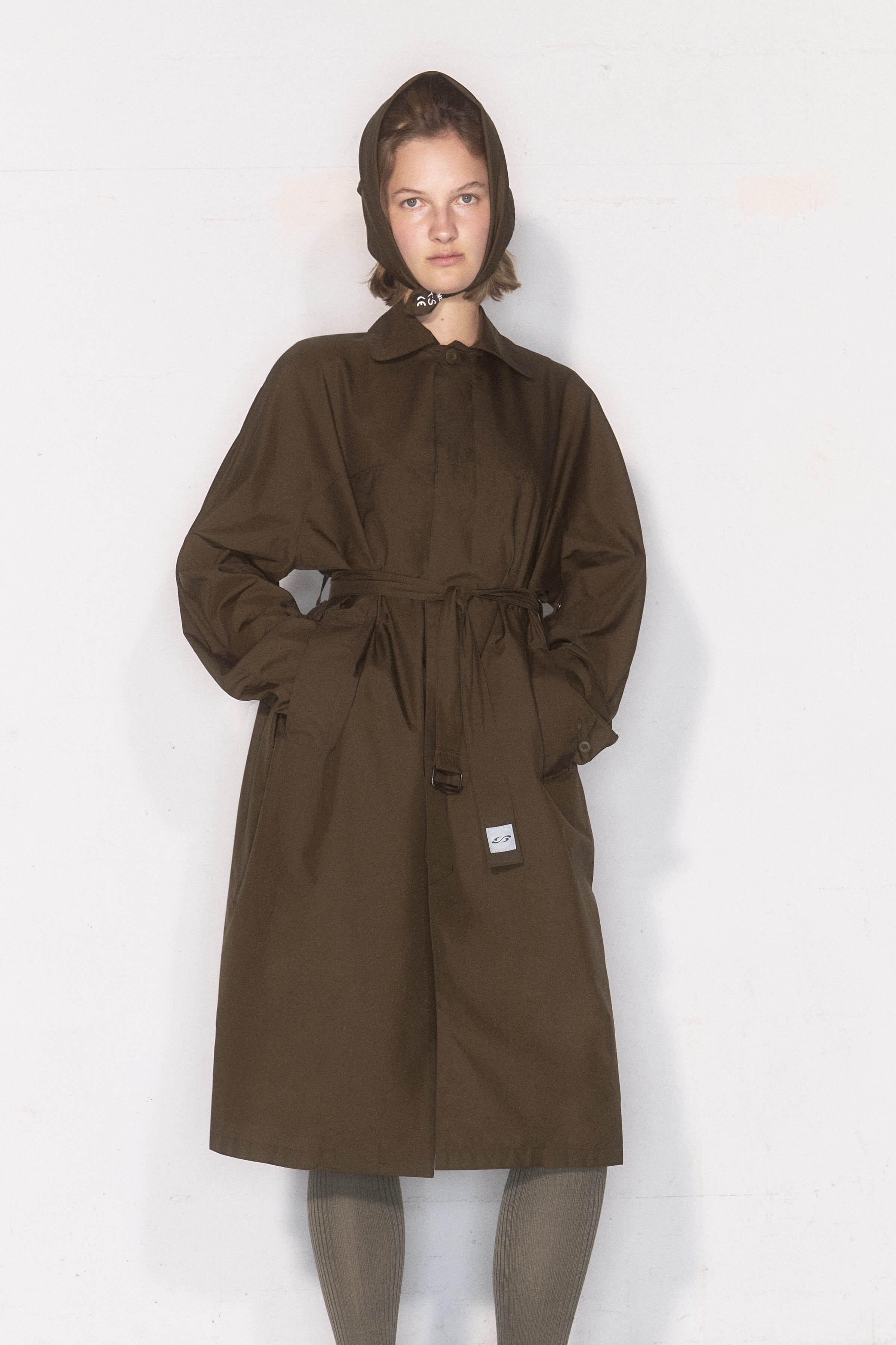 Model wearing GOGA Raincoat from UNIFORMA collection made by Tribute Brand and Čateks