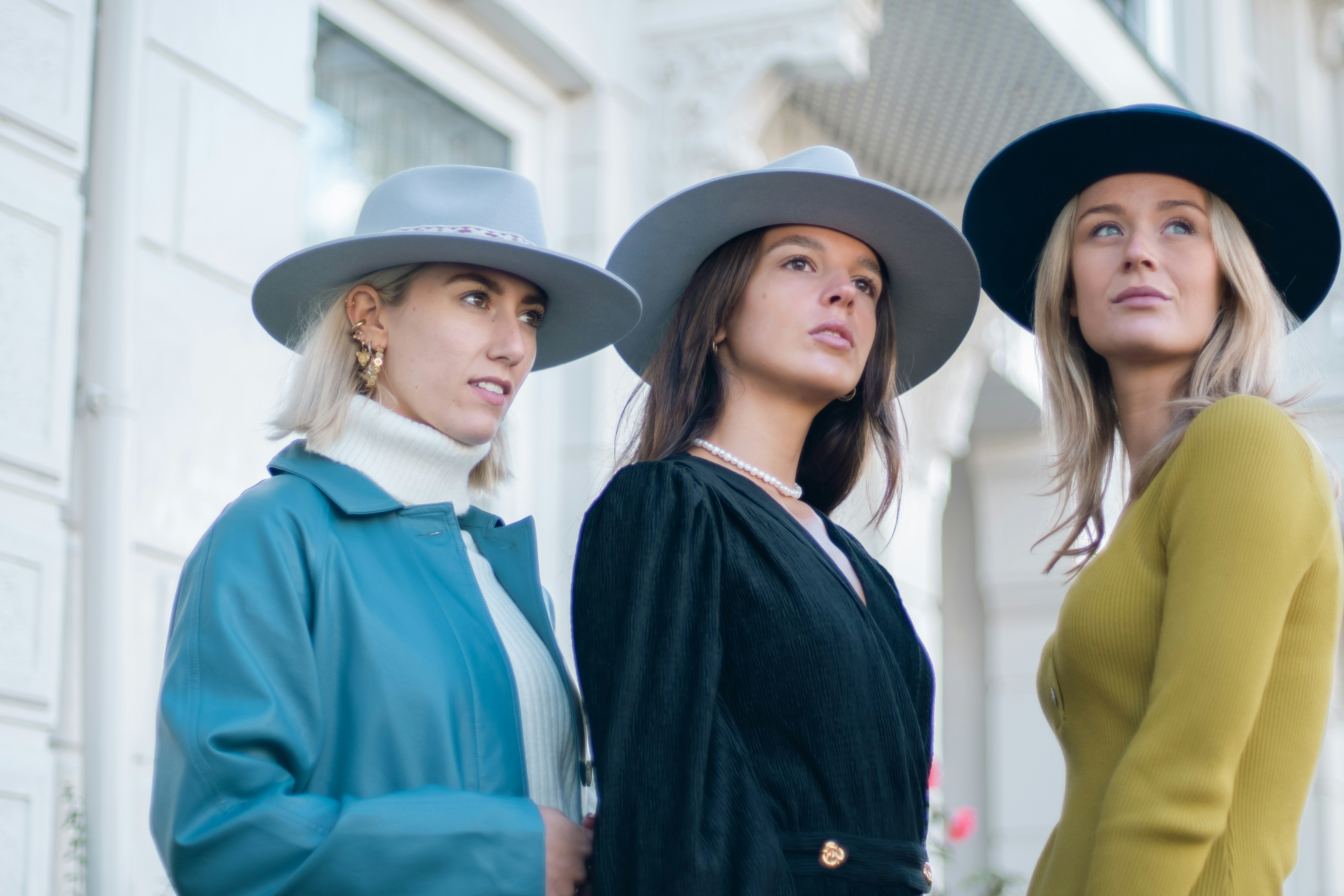 Three women looking into the distance with a blurry background