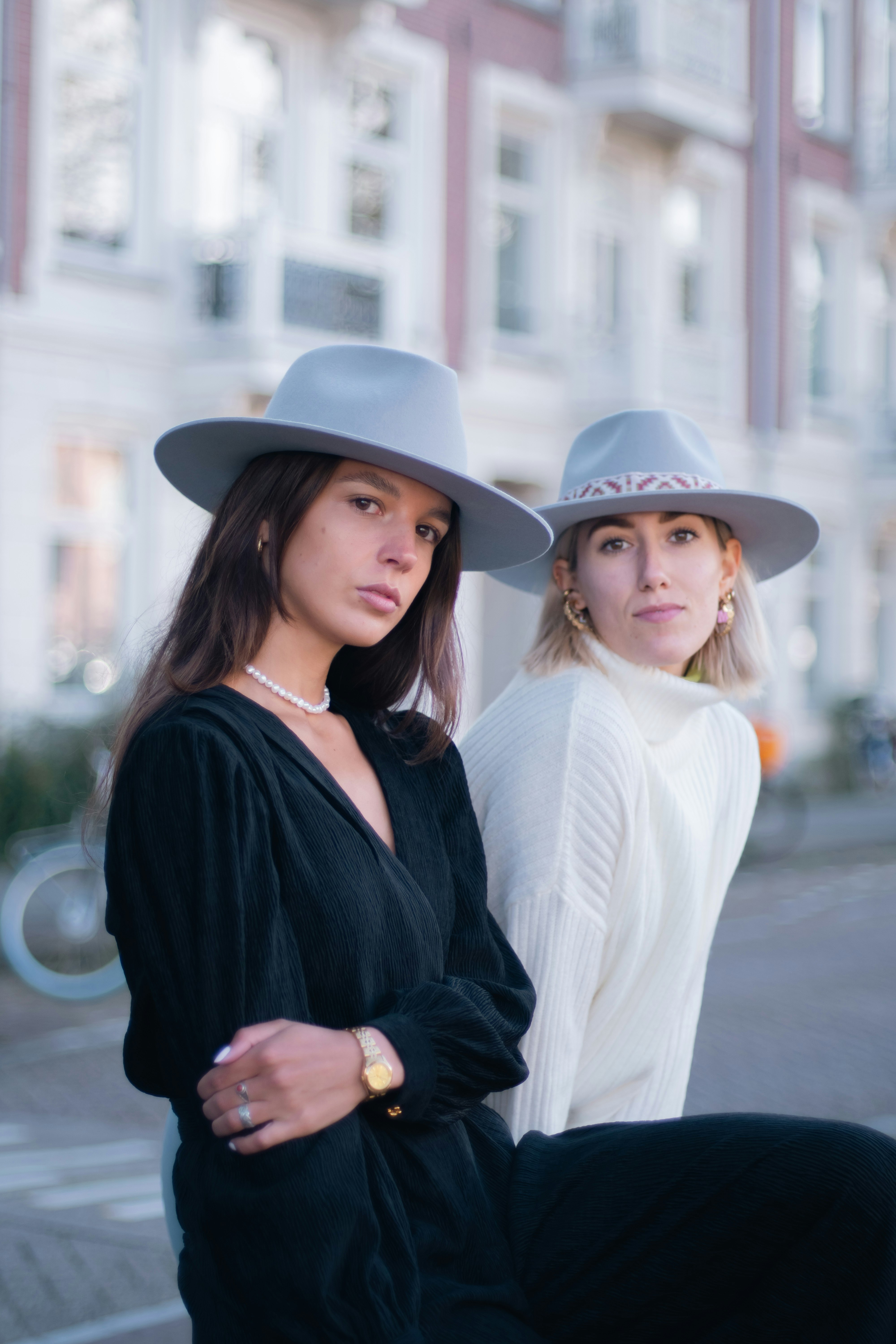 Two women looking into the camera with a blurry background