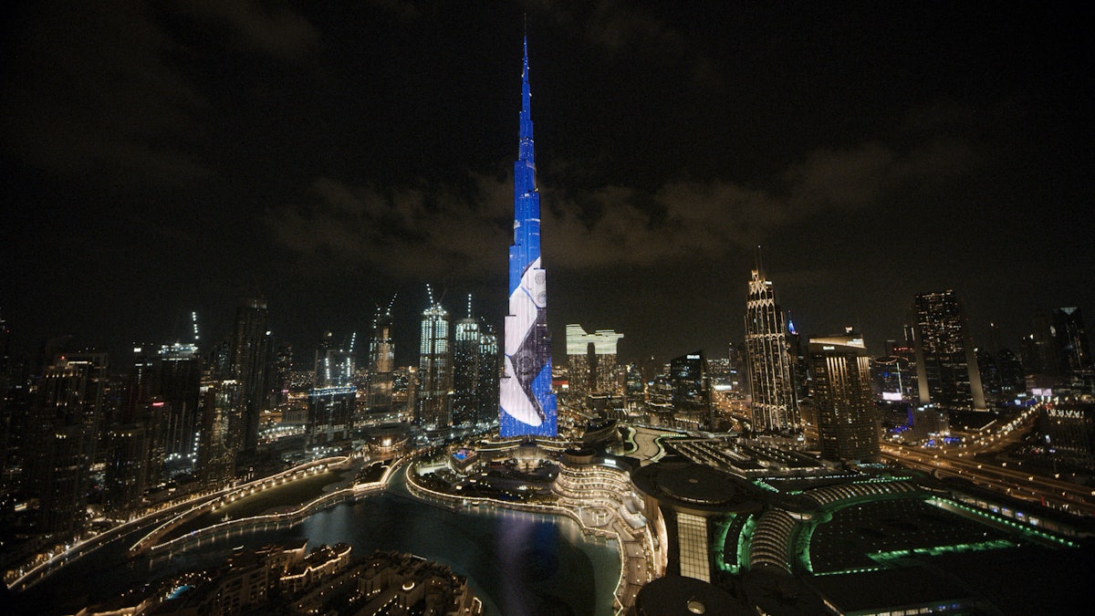 The Burj Khalifa in Dubai lit with the PlayStation 5 launch display across the night skyline.