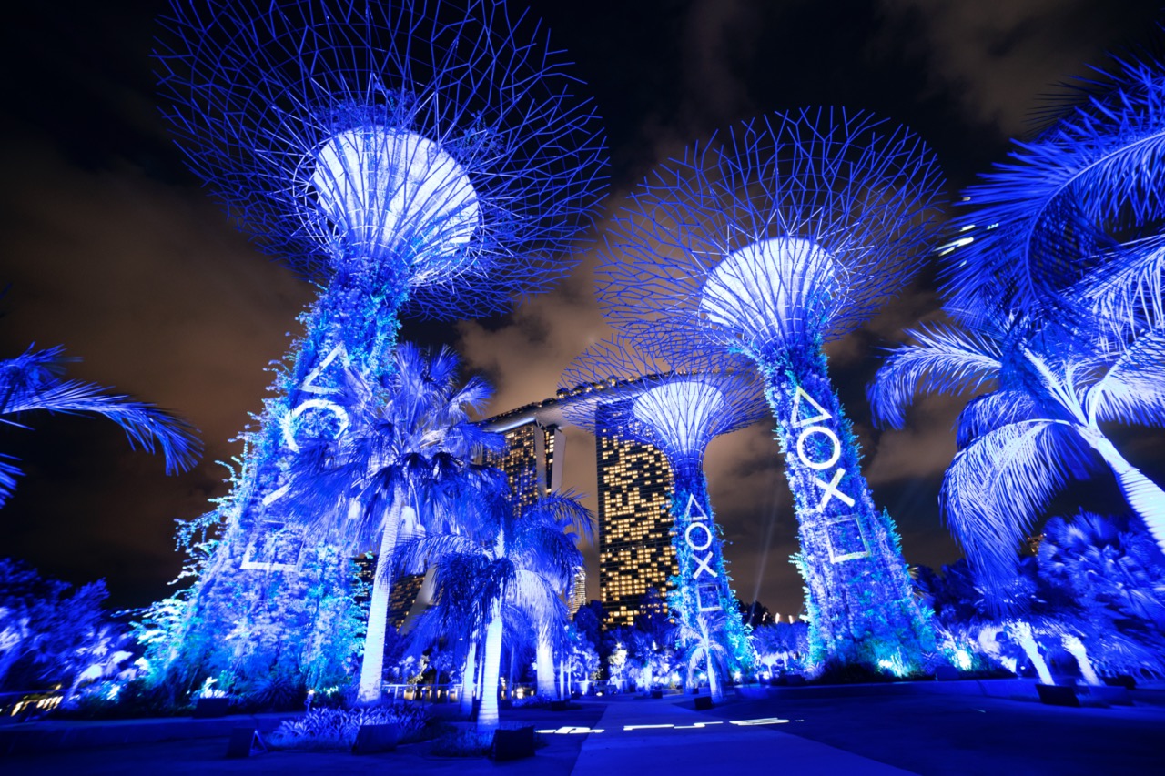 The Supertrees at Gardens by the Bay, Singapore, glowing PlayStation blue for the PS5 launch.
