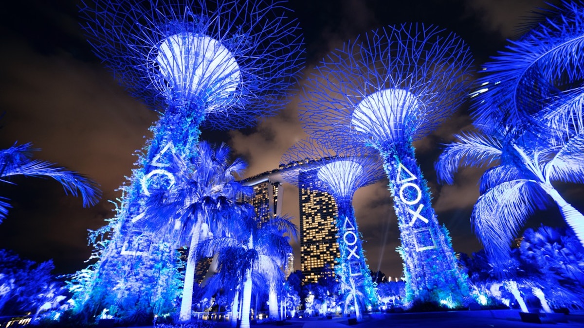 The Supertrees at Gardens by the Bay, Singapore, glowing PlayStation blue for the PS5 launch.