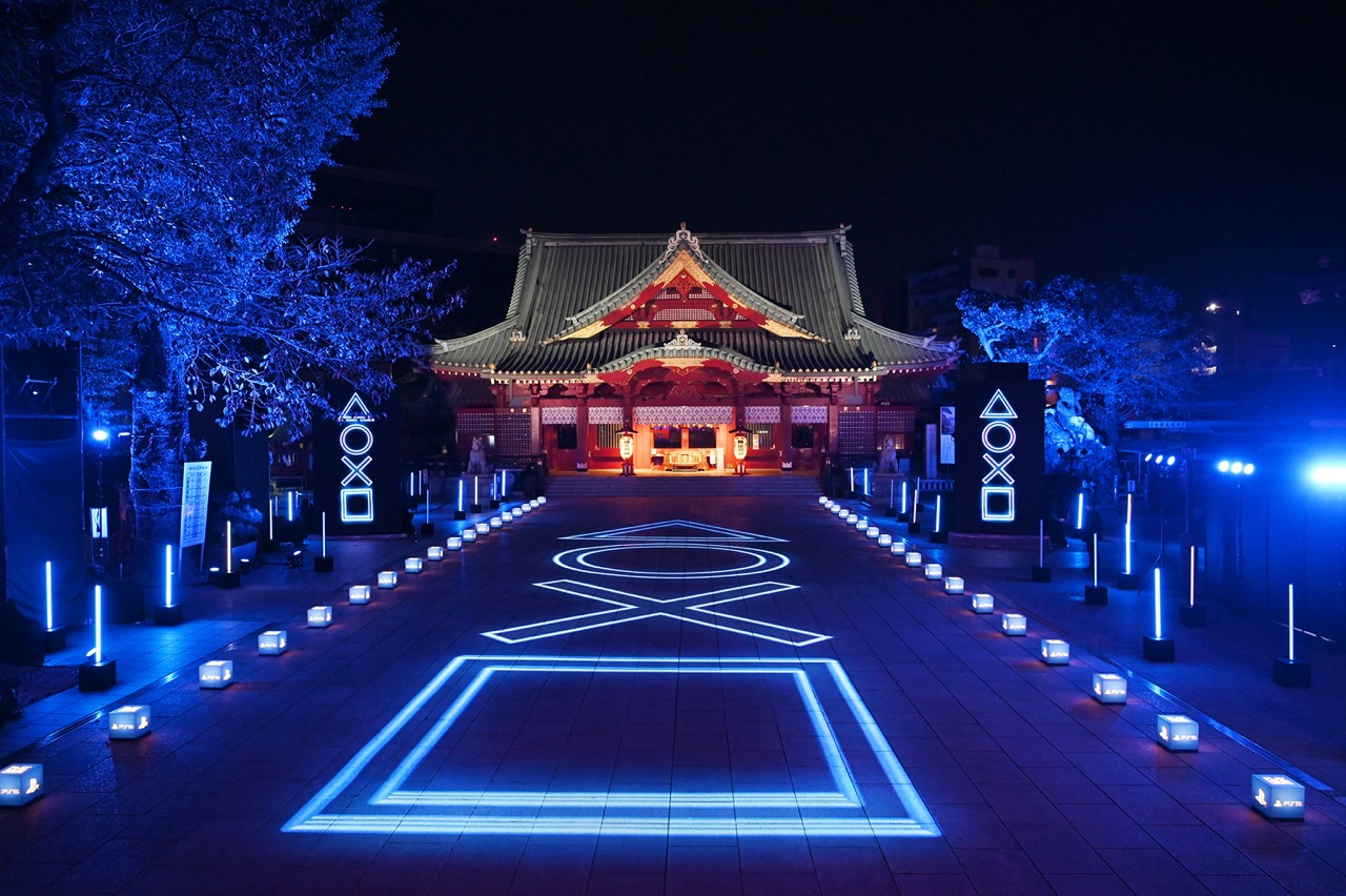Kanda Myojin shrine in Tokyo illuminated with glowing PlayStation symbols along its approach.