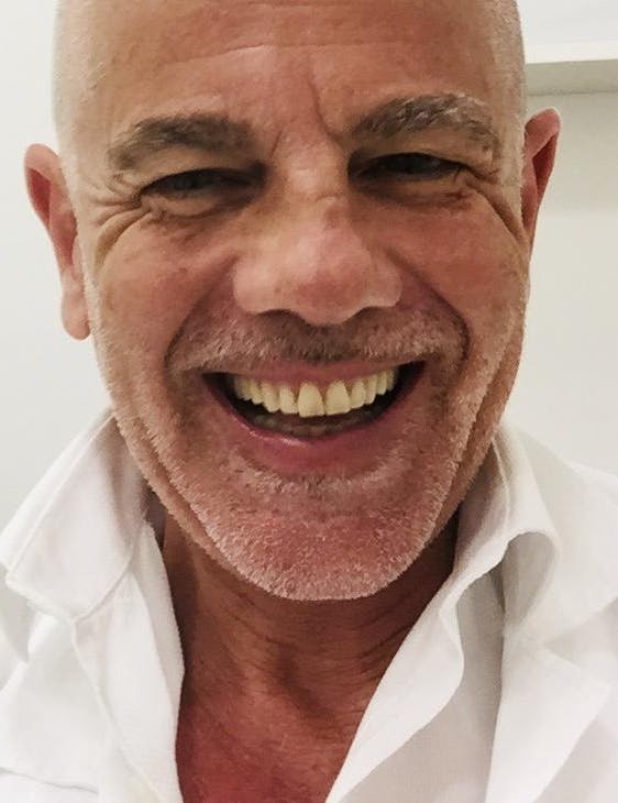 Smiling man in a white shirt.