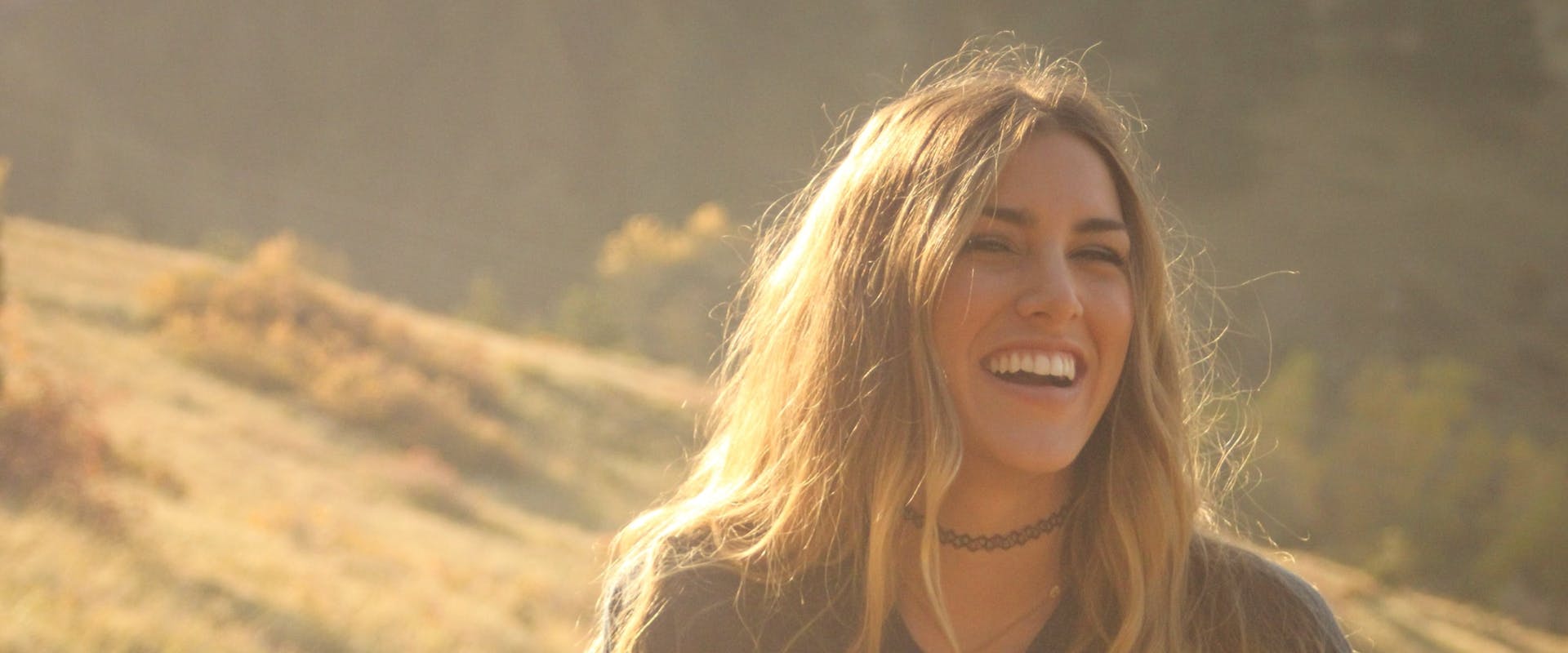 Girl laughing in a country field