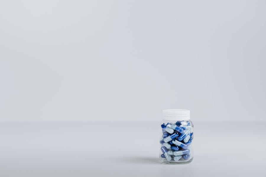 Blue and white tablets in a clear container