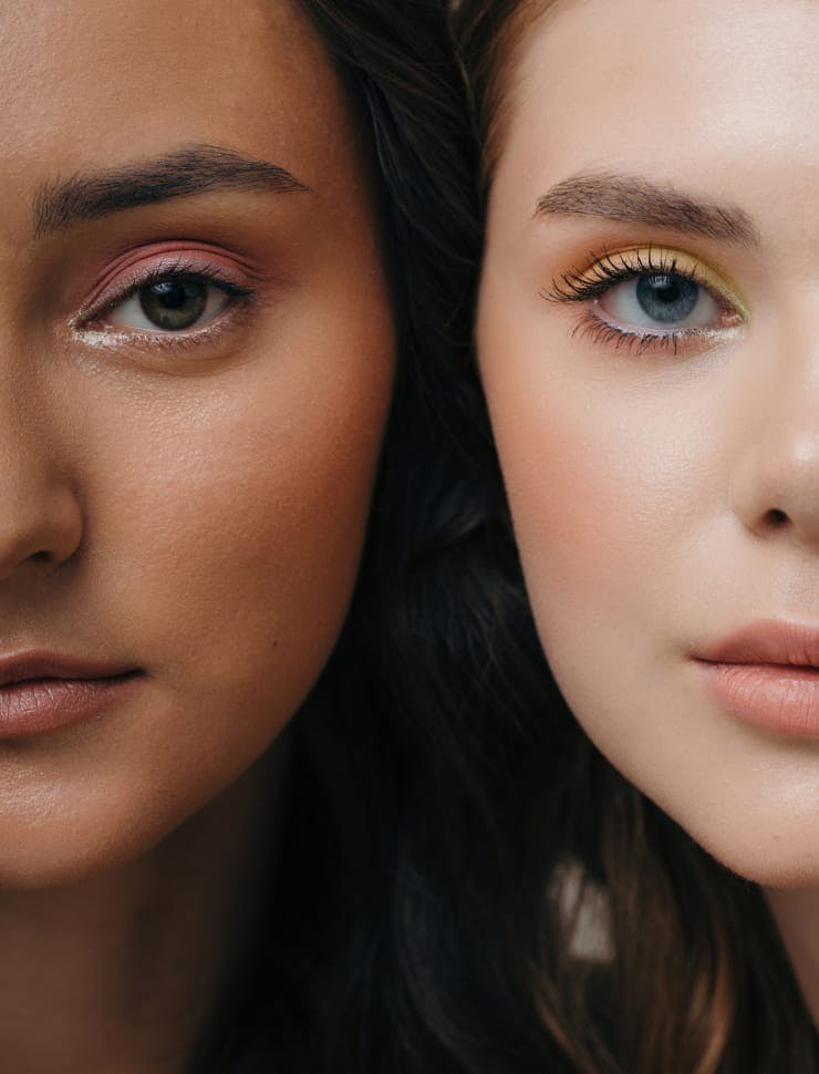 two women with different colored eyes and makeup are posing for a picture