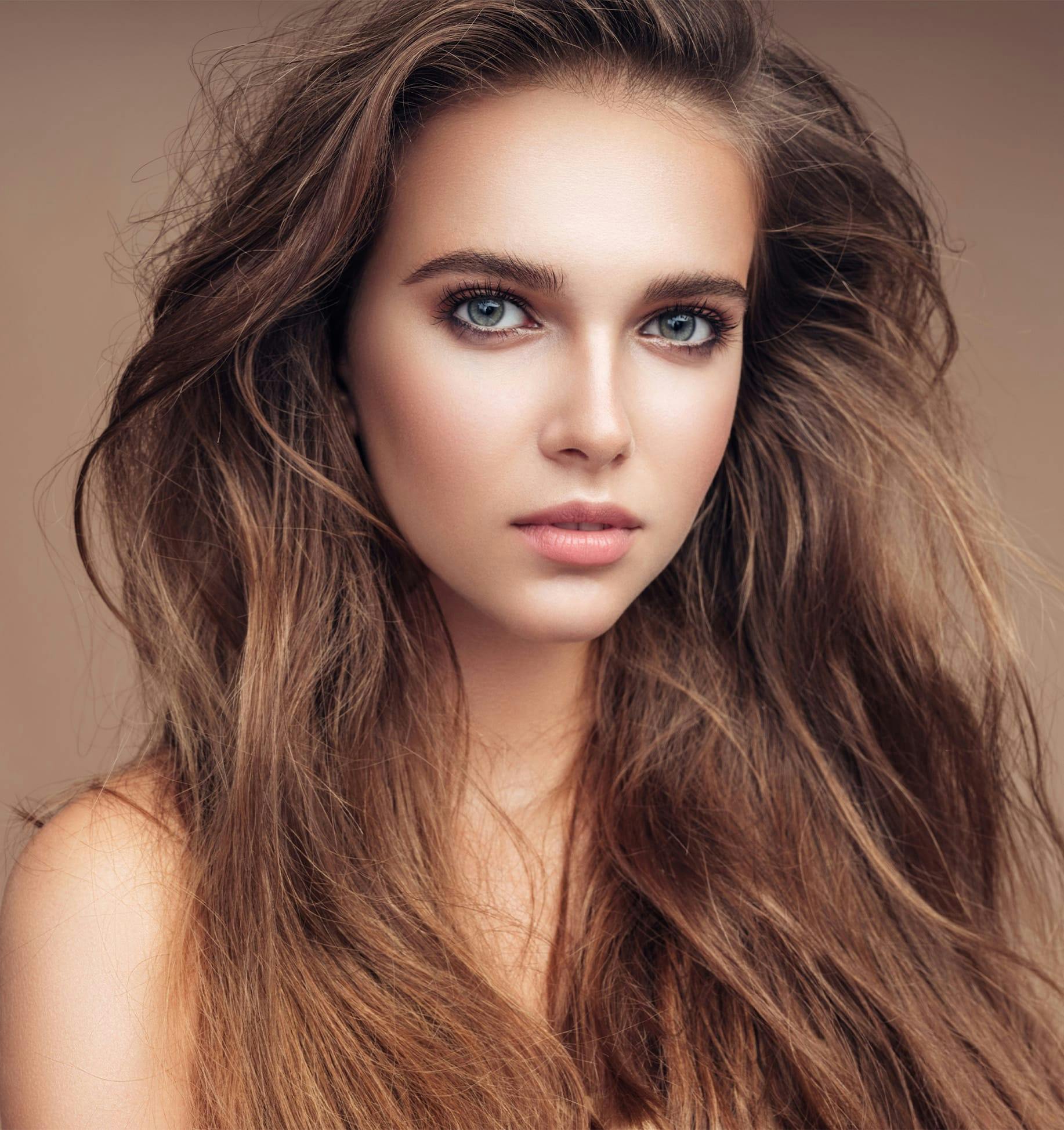 a close up of a woman with long hair down