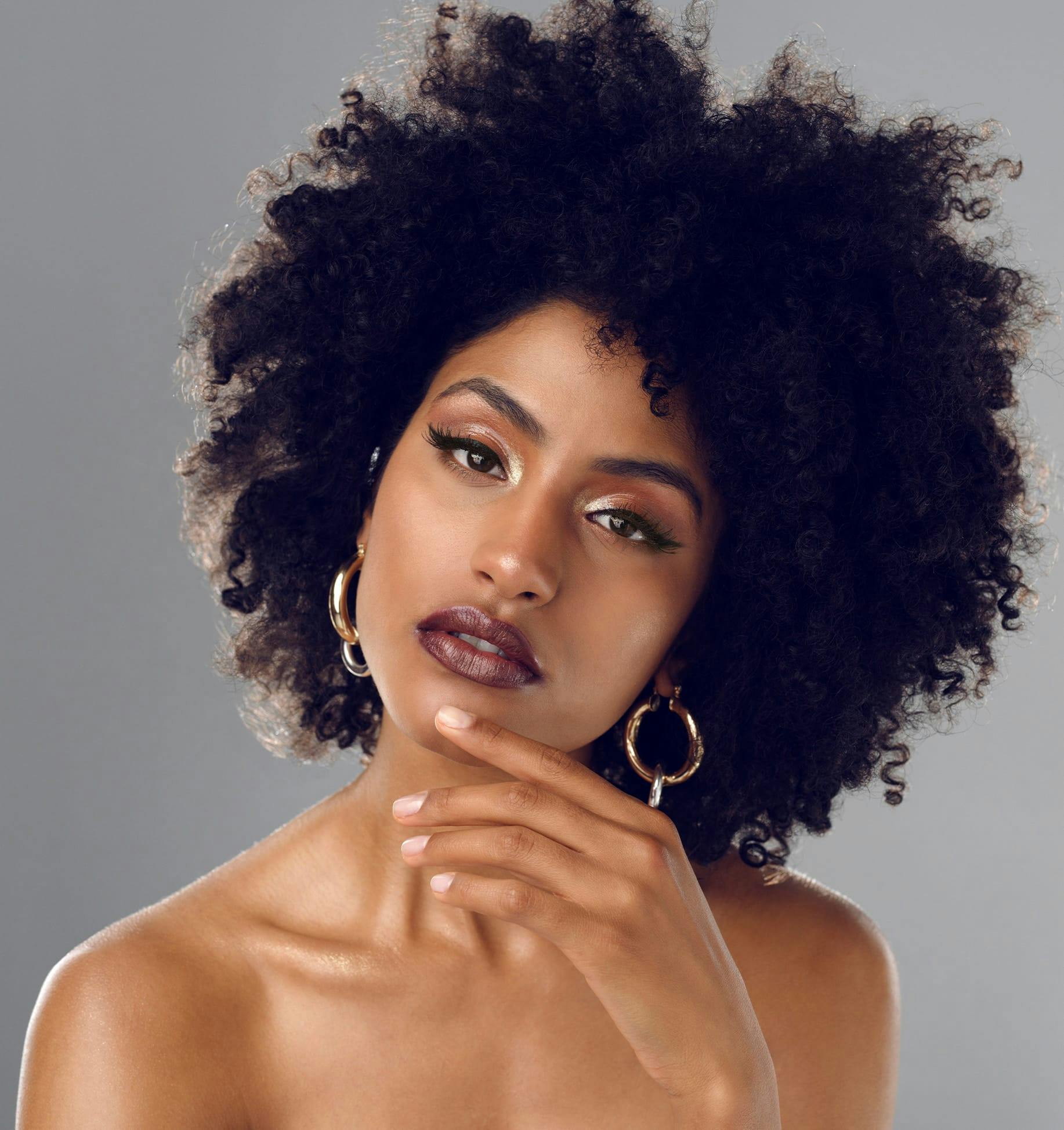 there is a woman with a big hoop earrings and a dress