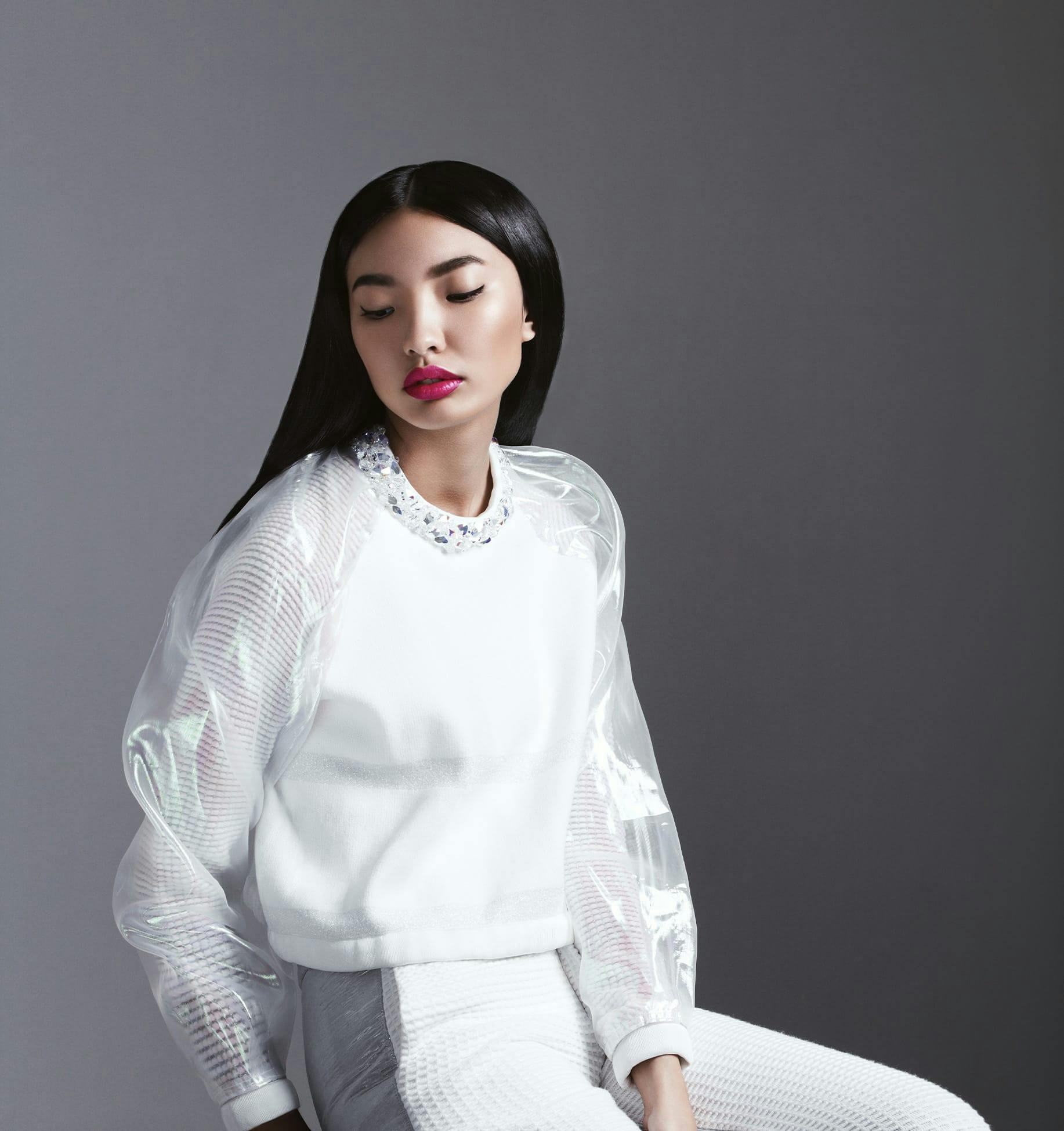 woman sitting on a stool with her eyes closed