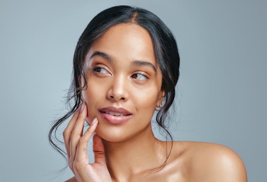 woman touching face and looking to the side