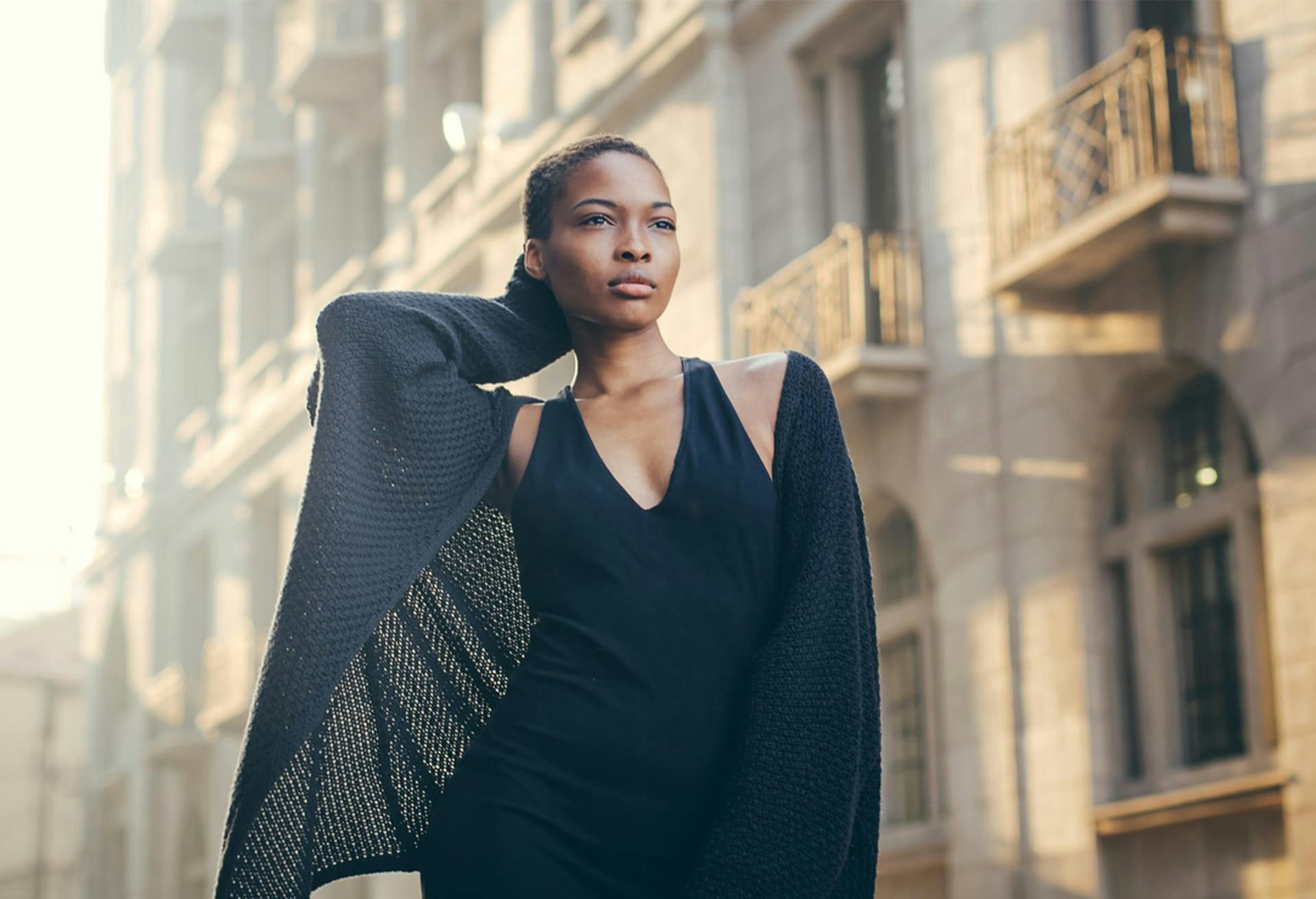 there is a woman in a black dress and a black coat
