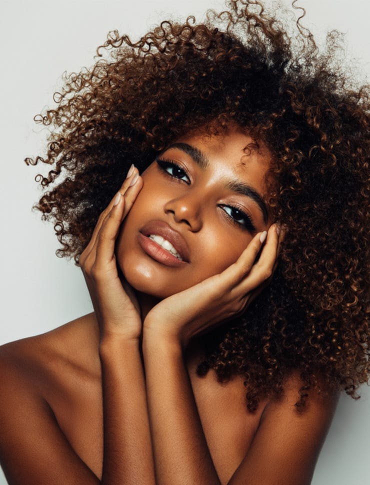 a woman with a very big afro hair posing for a picture