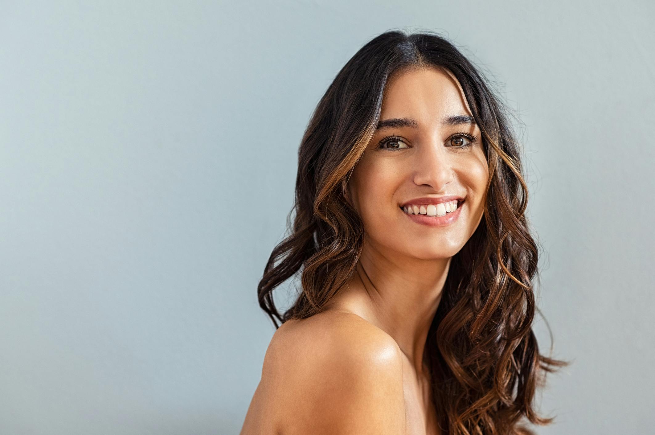 woman with long hair smiling
