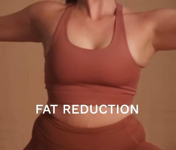 woman in a clay colored workout outfit