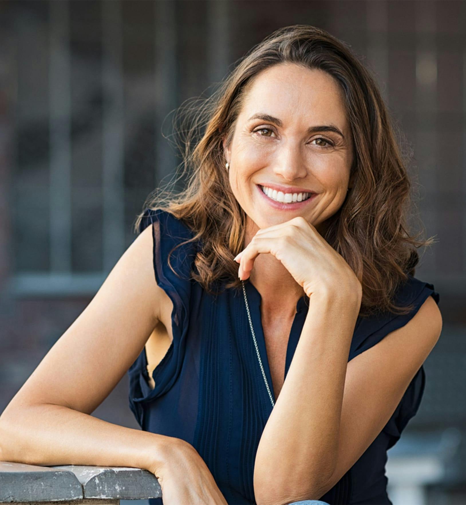 woman in a blue top smiling