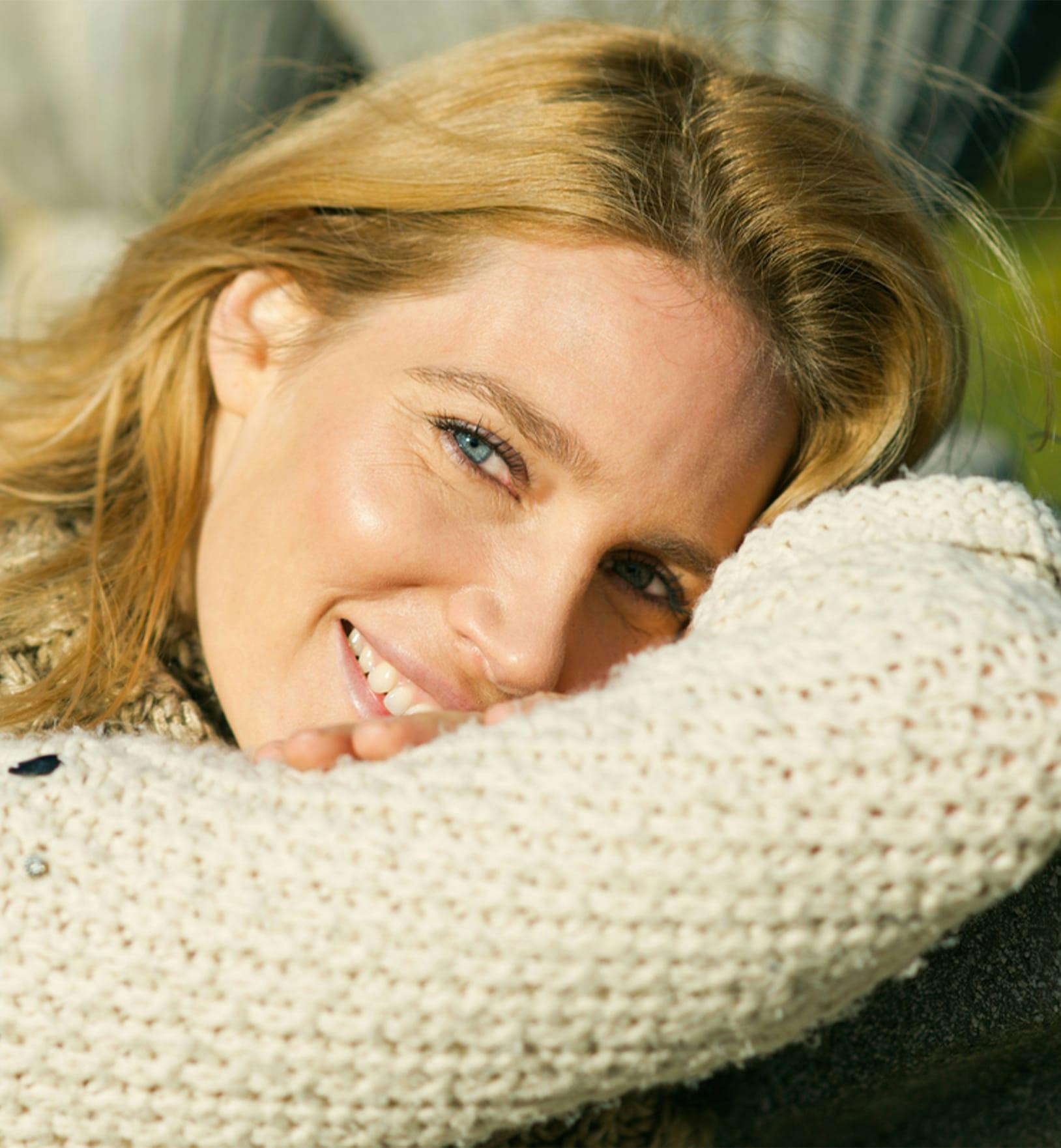 woman wearing a white knit sweater