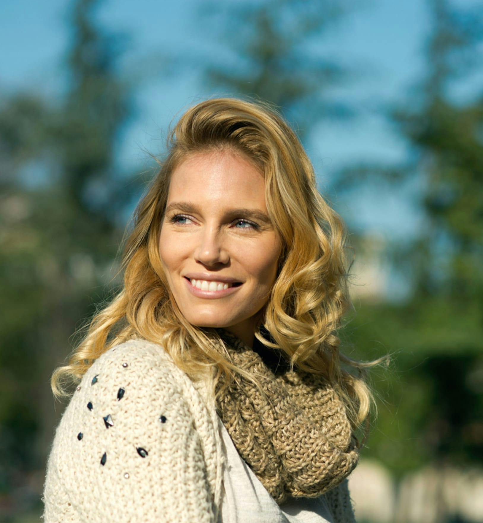 woman with curly blonde hair outside