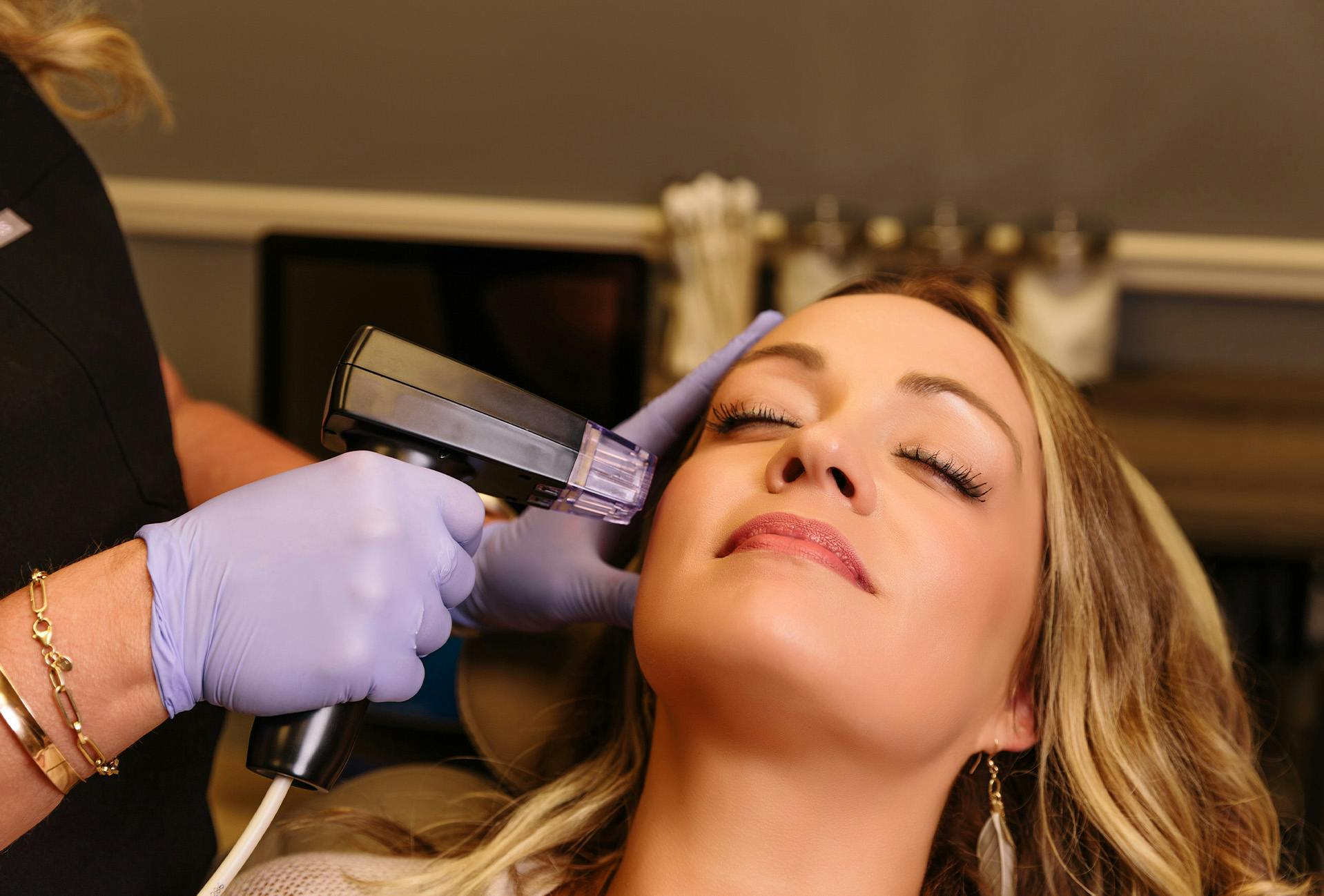 Woman receiving facial treatment at The Dermatology Center