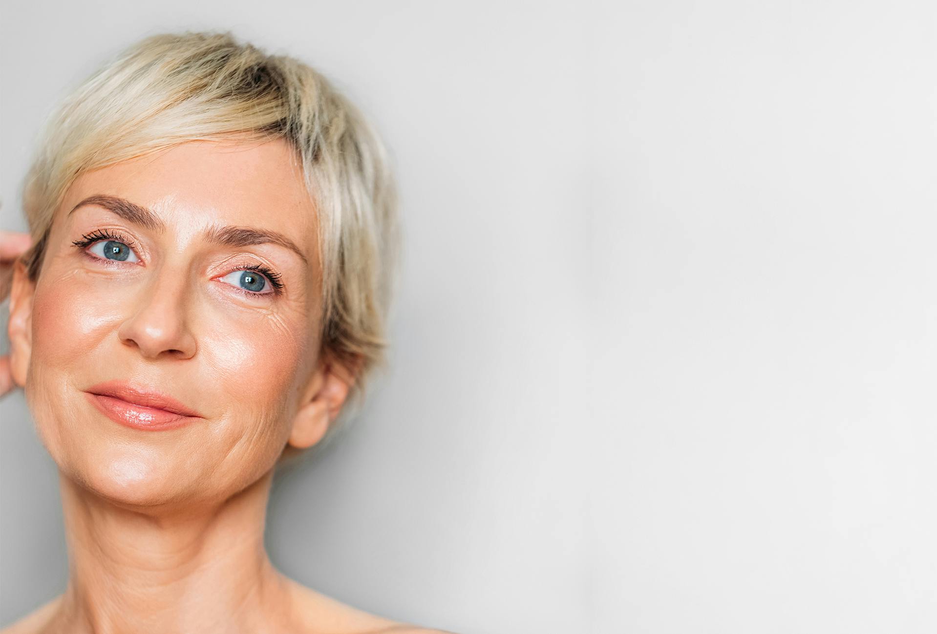 Middle-aged woman with very short blonde hair