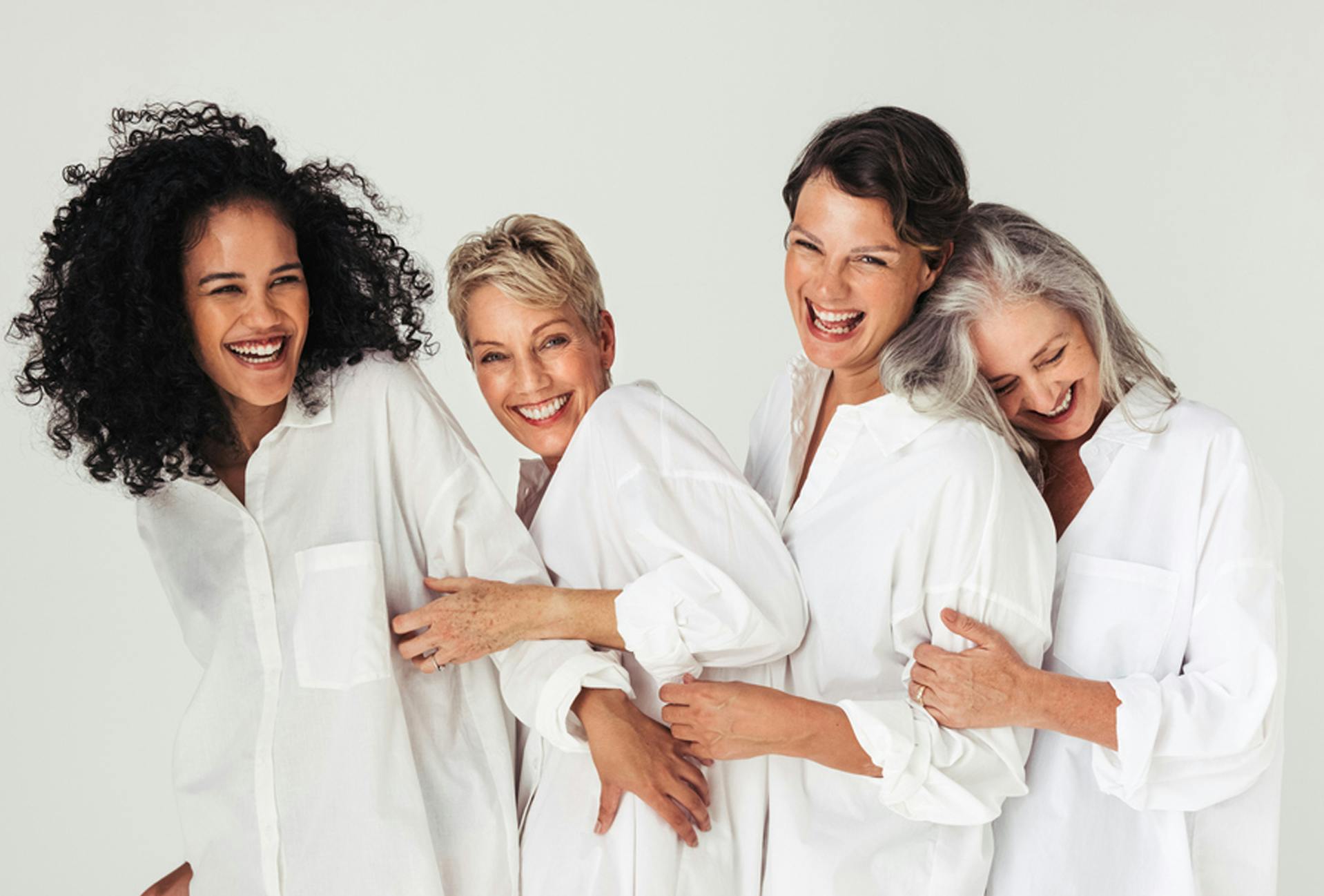 women in long white button up tops