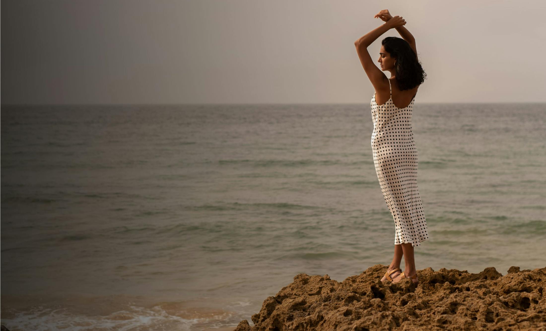 Woman Standing on an Ocean Cliff