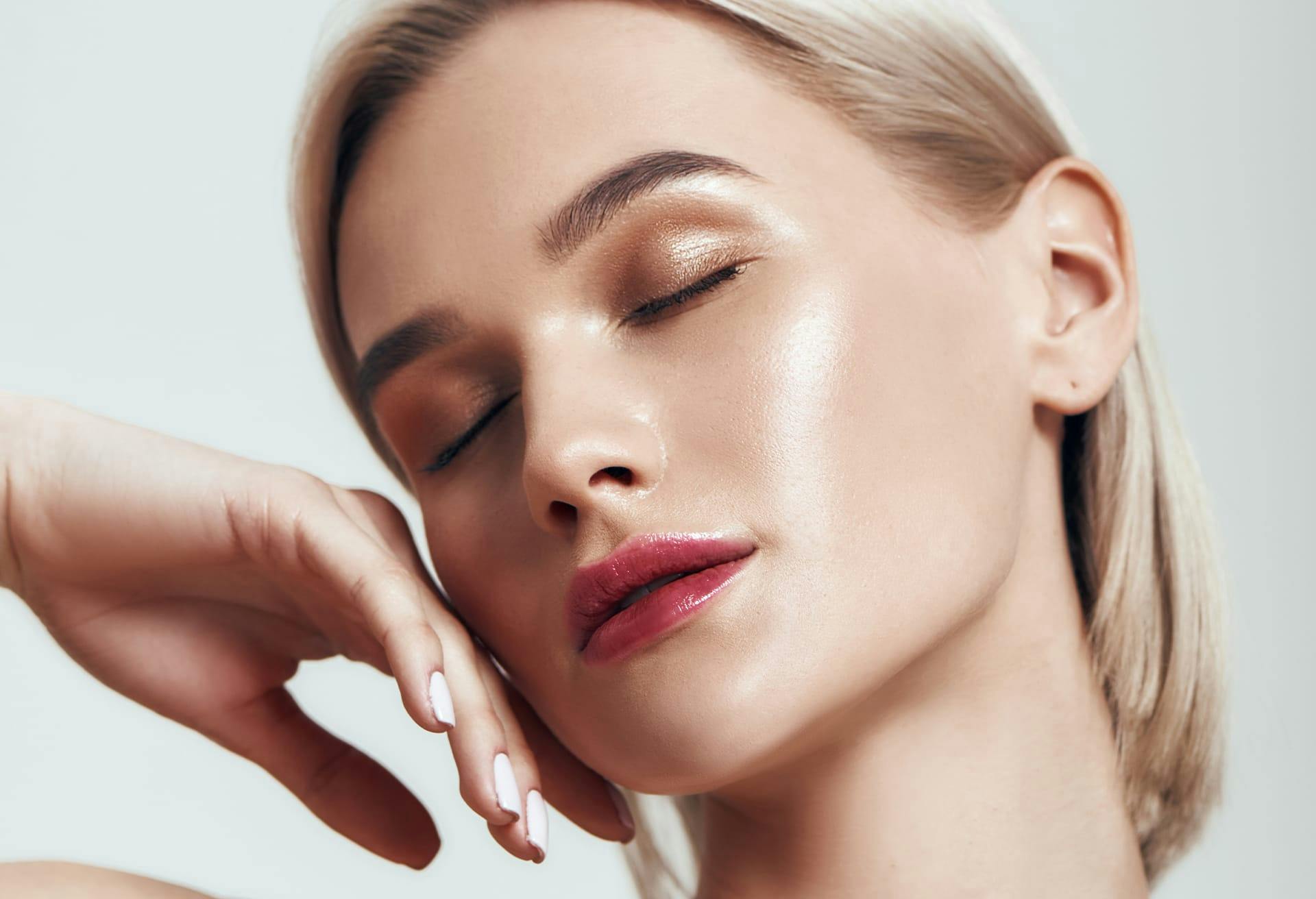 Woman with Short Blonde Hair Posing with Her Eyes Closed