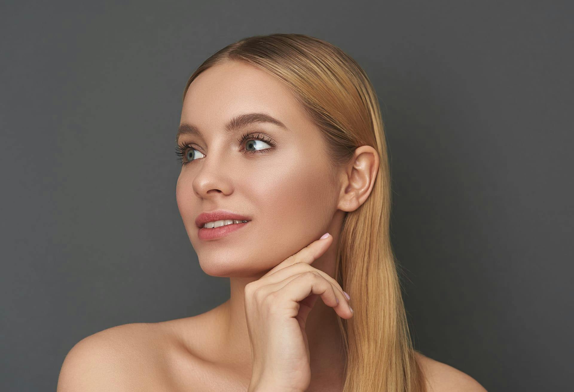Woman with Clear Skin and Sleek Blonde Hair