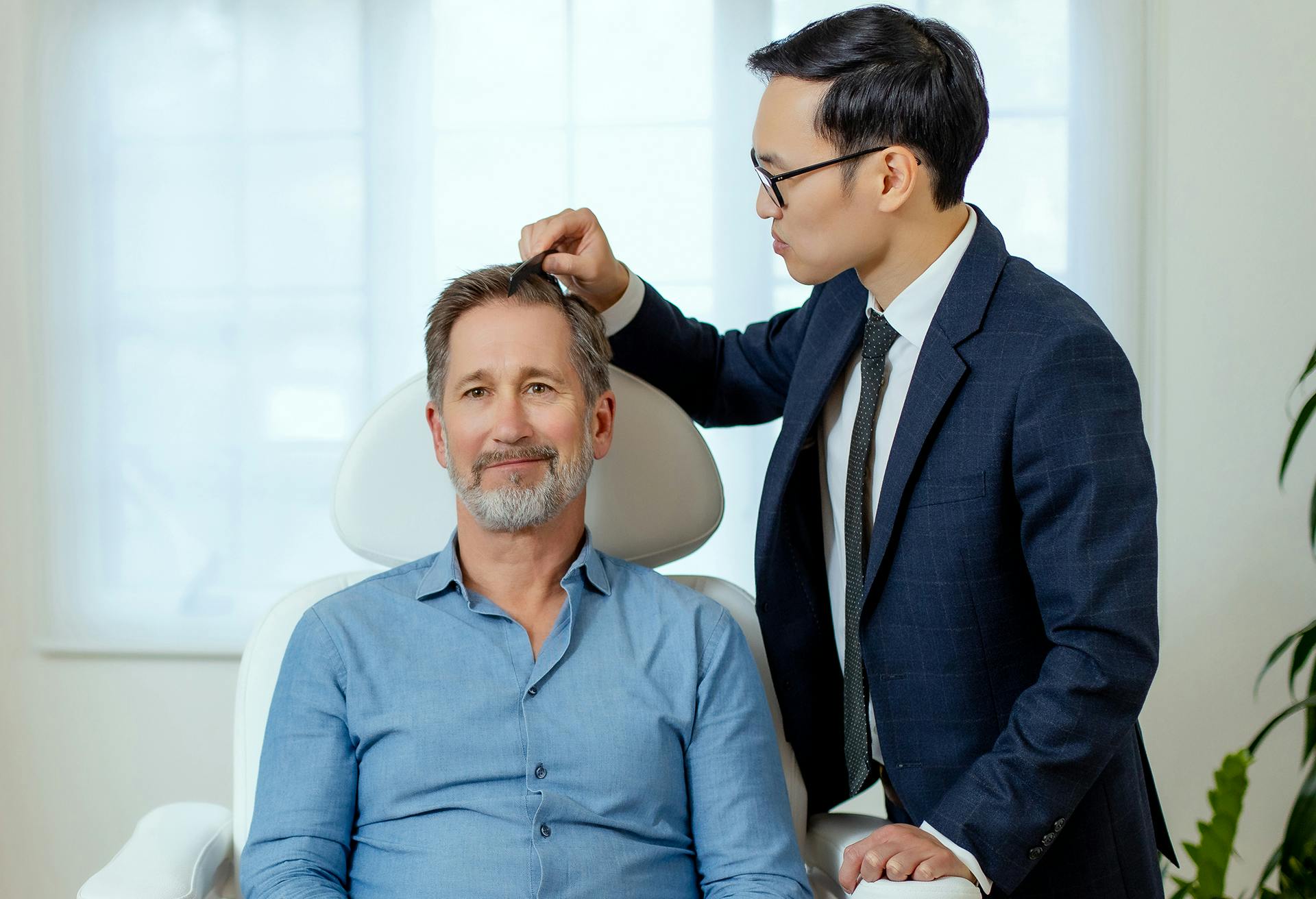 Dr. Timothy Ortlip Looking at a Male Patient's Hair