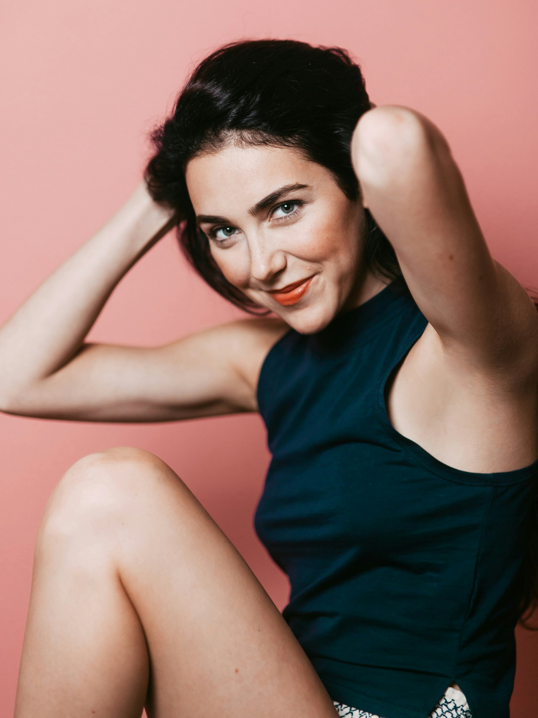 woman smiling lifting her upper arms